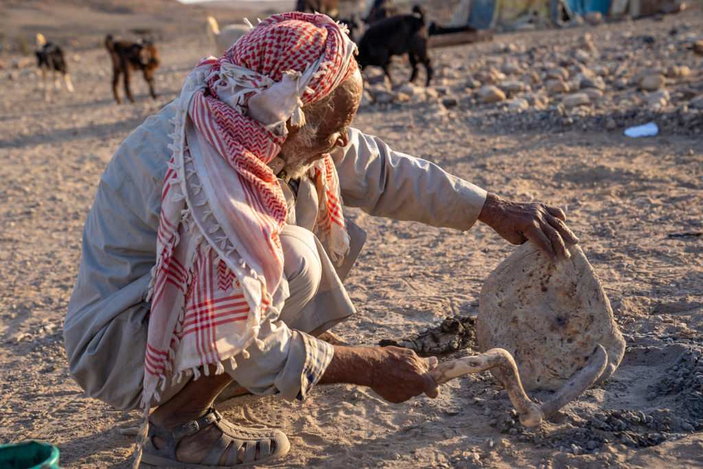 Bedouin finishes the bread that he prepared for guests, near Dana Biosphere Reserve, Wadi Arabah, Jordan, image by Marie Goff